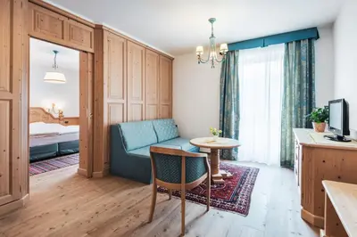 a living room with a couch and a table at Hotel Chalet Corso in San Vigilio Di Marebbe