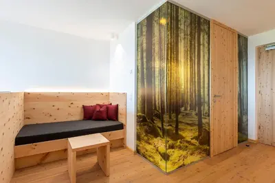 a room with a bed and a large aquarium at Hotel Seelaus in Alpe di Siusi