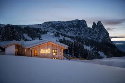 a building with a sign on it in the snow at Hotel Seelaus in Alpe di Siusi