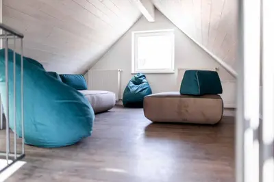a attic room with two bean bags and a slide at Stay COOPER l Guesthouse zum Löwen in Merano