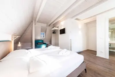 a bedroom with two white beds in a room at Stay COOPER l Guesthouse zum Löwen in Merano