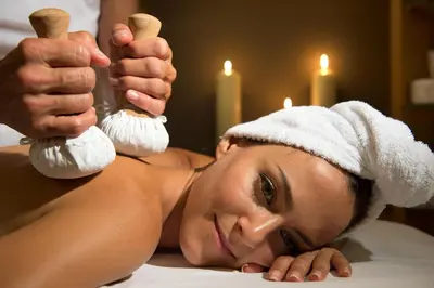 a woman laying on a bed with a towel on her head at Sporthotel Sonne in Alpe di Siusi