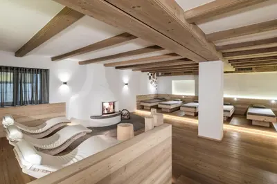 a living room with wooden ceilings and wooden floors at Sporthotel Sonne in Alpe di Siusi