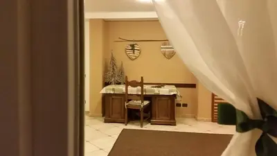 a room with a desk and a curtain at Santa Maria ad Nives in Canazei