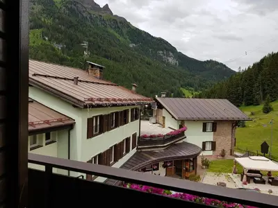 a view from a balcony of a building with mountains at Santa Maria ad Nives in Canazei