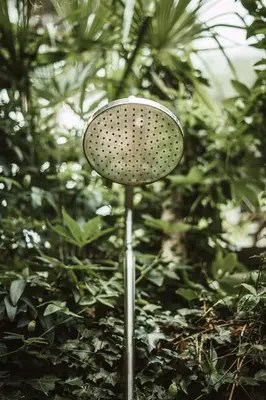 a metal stand in front of a bush at Ottmanngut Suite and Breakfast in Merano