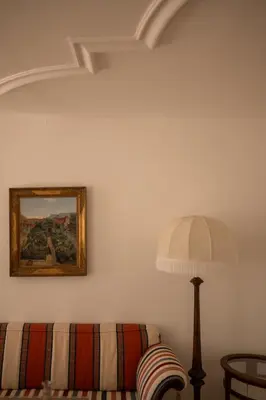 a living room with a couch and a lamp at Ottmanngut Suite and Breakfast in Merano