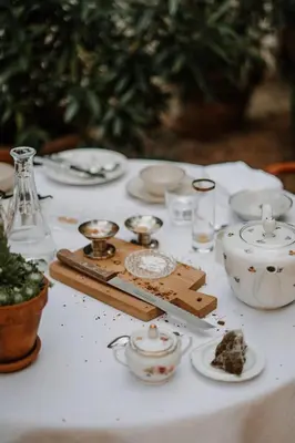 a white table topped with dishes and a tea set at Ottmanngut Suite and Breakfast in Merano