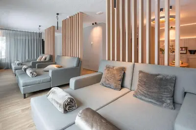 a living room with a couch and two chairs at Hotel Lindnerhof in San Lorenzo di Sebato