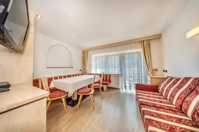 a dining room with a table and chairs at Apartments & Garnì Pre Da Nai in La Villa