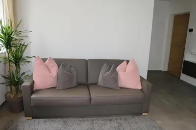 four pillows on a couch in a living room at Appartment Larcher - Manzoni in Merano