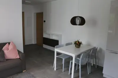 a living room with a white table and chairs at Appartment Larcher - Manzoni in Merano