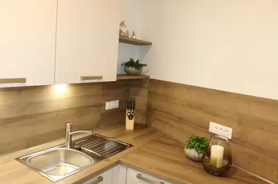 a kitchen with a sink and a wooden counter top at Appartment Larcher - Manzoni in Merano