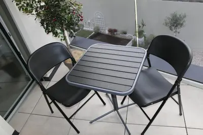 a table and two chairs on a patio at Appartment Larcher - Manzoni in Merano