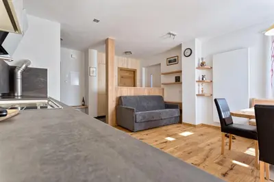 a kitchen and living room with a couch and a table at Tschörlerhof in Barbiano