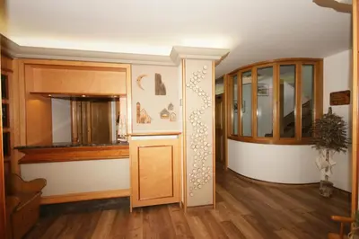 a room with a wooden door and a cabinet at Hotel Vallechiara in Moena