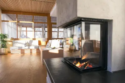 a living room with a fireplace in a living room at Hotel Monte Sella in San Vigilio Di Marebbe