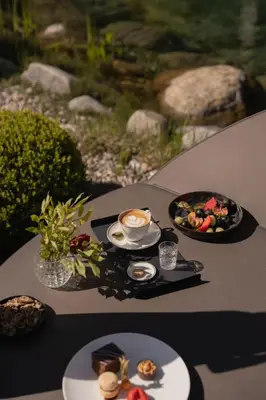 a table with two plates of food and a cup of coffee at Chalet Mirabell in Avelengo