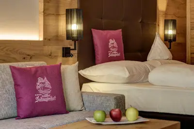 a hotel room with a bed with apples on a table at Hotel Saltauserhof in Saltusio
