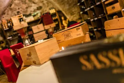 a wine cellar with wooden boxes on a table at Hotel Saltauserhof in Saltusio