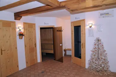 a hallway with two doors and a christmas tree at Hotel Ciamol in Mazzin