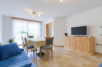 a living room with a table and a tv at Agritur Belsogno B&B in Brez