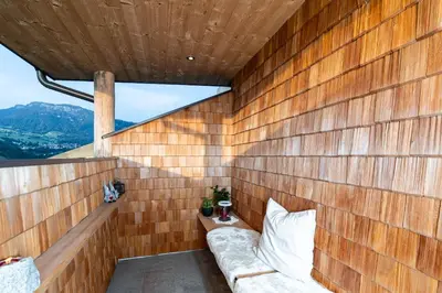a wooden wall with a couch in a room at Mesnerhof my Paradise in Fiè