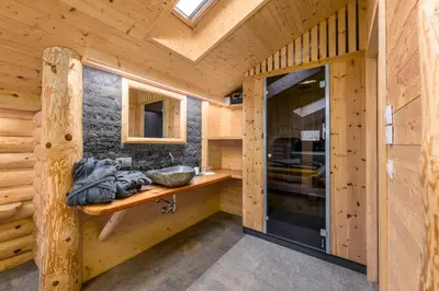 a bathroom in a log cabin with a sink at Mesnerhof my Paradise in Fiè