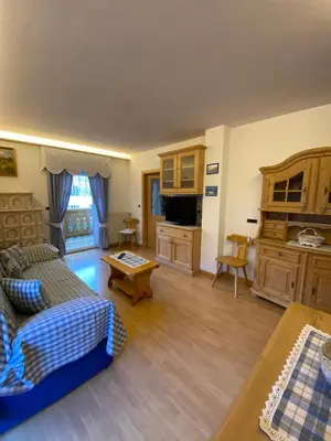 a living room with a couch and a table at Cesa Bernard in Pozza di Fassa