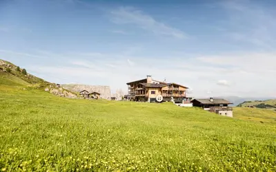a building on top of a snow covered mountain at Hotel Goldknopf in Alpe di Siusi