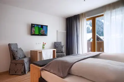 a swimming pool in a house with a bathroom at Hotel Italia in Corvara in Badia