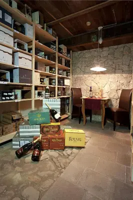 a room with a table and a bunch of books at Hotel Italia in Corvara in Badia