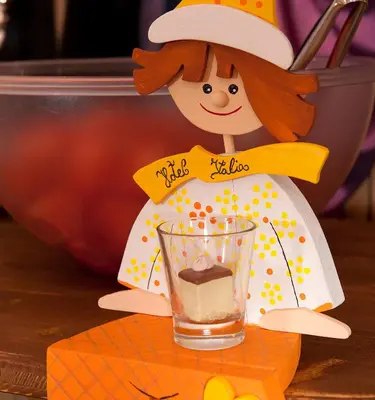 a figurine of a woman holding a glass of pudding at Hotel Italia in Corvara in Badia