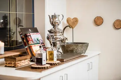a counter with a mixer and a book on it at Granpanorama Wellnesshotel Sambergerhof Superior in Villandro