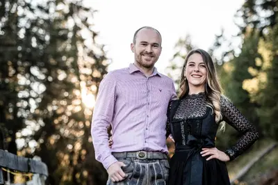 a man and a woman standing next to each other at Granpanorama Wellnesshotel Sambergerhof Superior in Villandro
