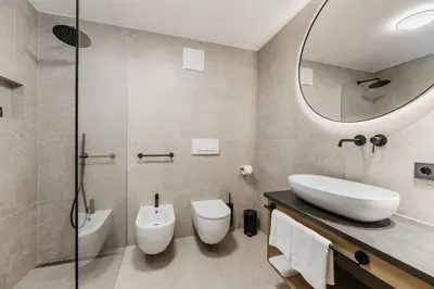 a bathroom with a sink and a toilet and a mirror at Miraval Perathoner Andreas in Ortisei