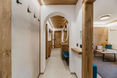 an archway leads into the hallway of a house at Miraval Perathoner Andreas in Ortisei