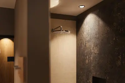 a bathroom with a shower with a shower head on the wall at Hotel B&B Feldmessner in Brunico