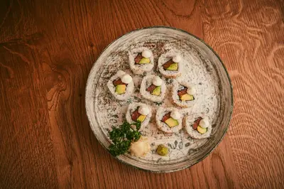 a plate of food on a wooden table at Hotel B&B Feldmessner in Brunico