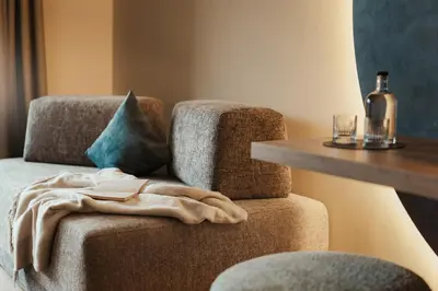 a towel sitting on a chair next to a table at Hotel B&B Feldmessner in Brunico