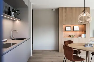 a kitchen and dining room with a table and chairs at Astor Apartments in Valdaora