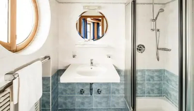 a bathroom with a sink and a shower at Astor Apartments in Valdaora