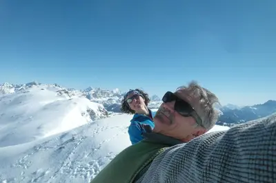 a man and a woman standing on top of a snow covered mountain at Residence Hofer in Bressanone