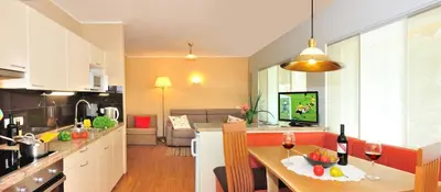 a kitchen and living room with a table with wine glasses at Residence Hofer in Bressanone