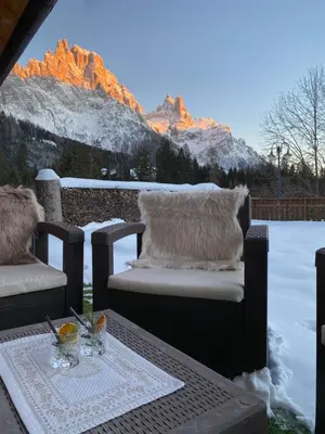 two glasses of wine and a bowl of food in a hot tub at Hotel Europa in San Martino di Castrozza