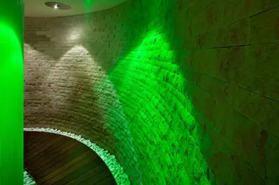 a brick wall with green lights on it at Sayonara Nature & Wellness Hotel in San Martino di Castrozza