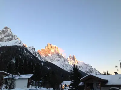 a view of a mountain with snow on it at Hotel Jolanda in San Martino di Castrozza
