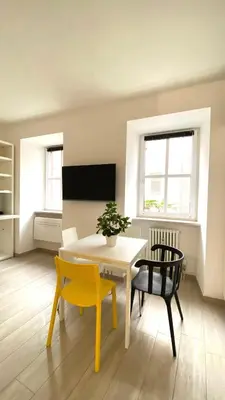 a dining room with a table and two chairs at Life Studio & City Bike in Bolzano