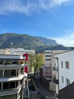 a view of a city with mountains in the background at Life Studio & City Bike in Bolzano