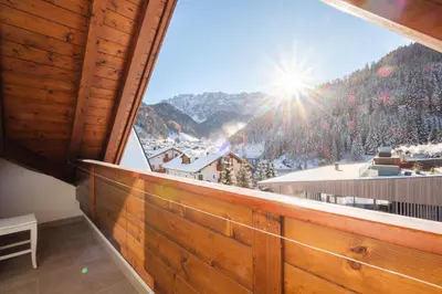 a balcony with a view of a snow covered mountain at Wellness Residence Villa Leck in Selva di Val Gardena